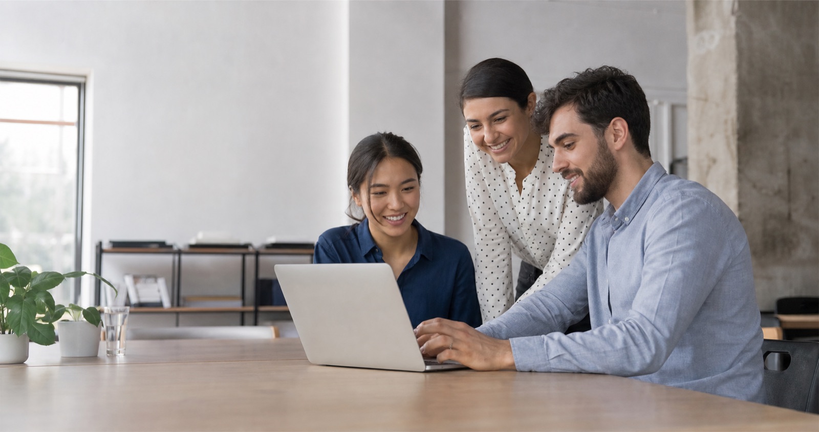 Business team working together around a laptop